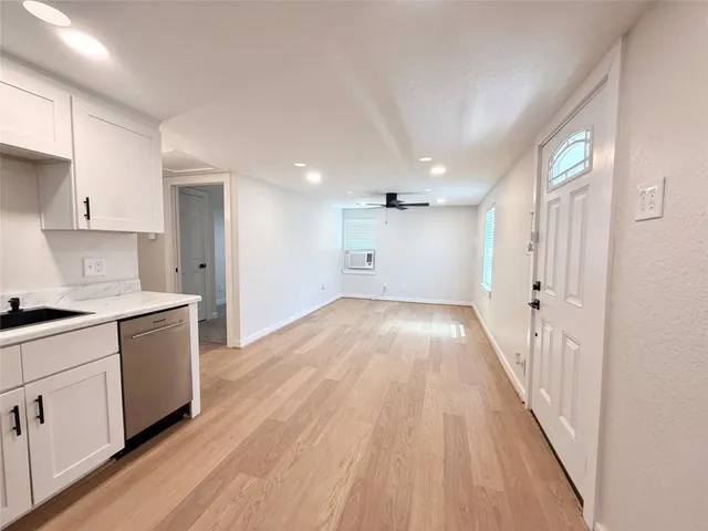 a view of a kitchen with wooden floor and electronic appliances