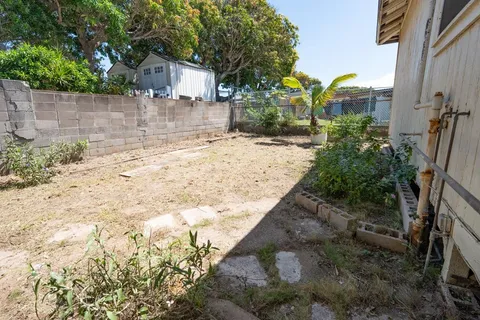 a view of a yard with a house in the background