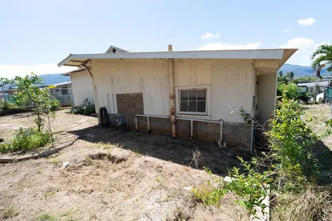 a backyard of a house with yard and outdoor seating