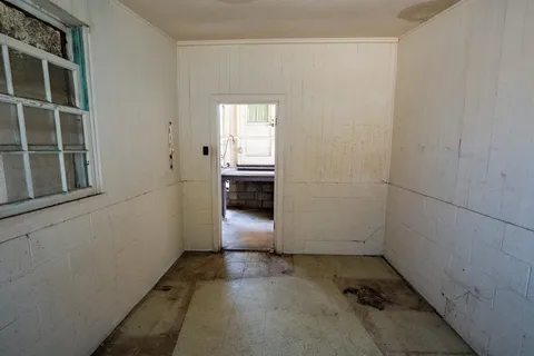 a view of storage and utility room with a door