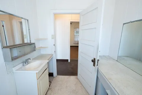 a bathroom with a sink a toilet and a mirror