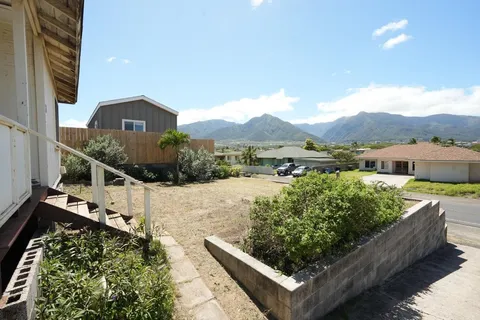 a view of a house with a yard and a sitting area