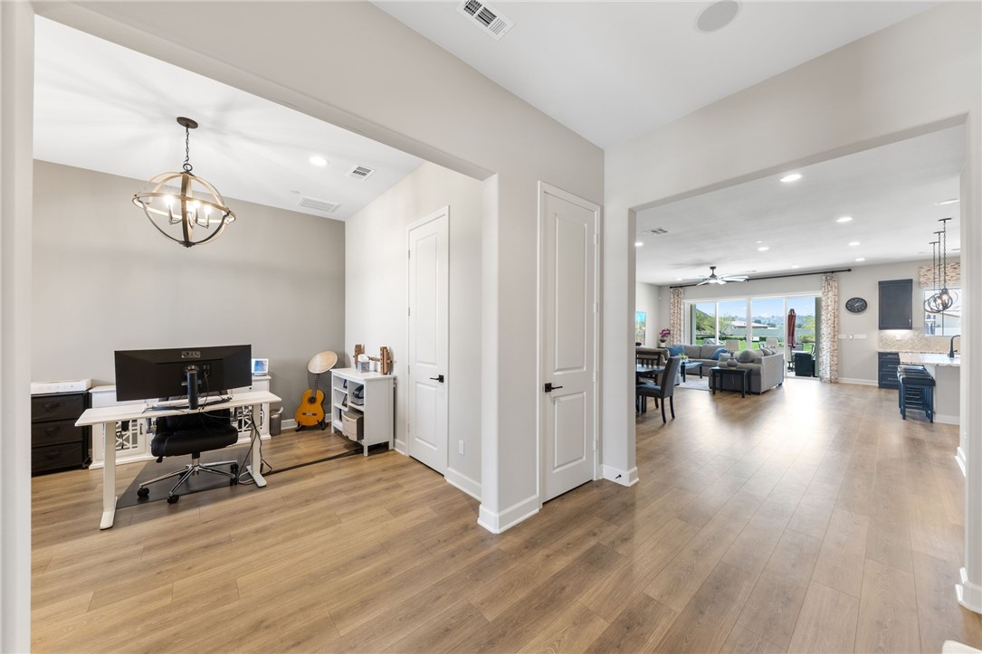 Spacious office or den with a closet and elegant lighting.