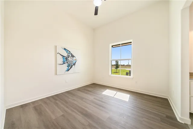 a spacious bathroom with a tub sink and mirror