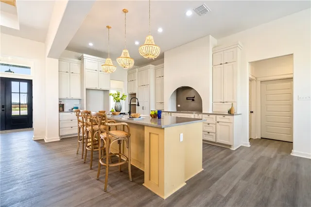 a view of a dining room with furniture and chandelier