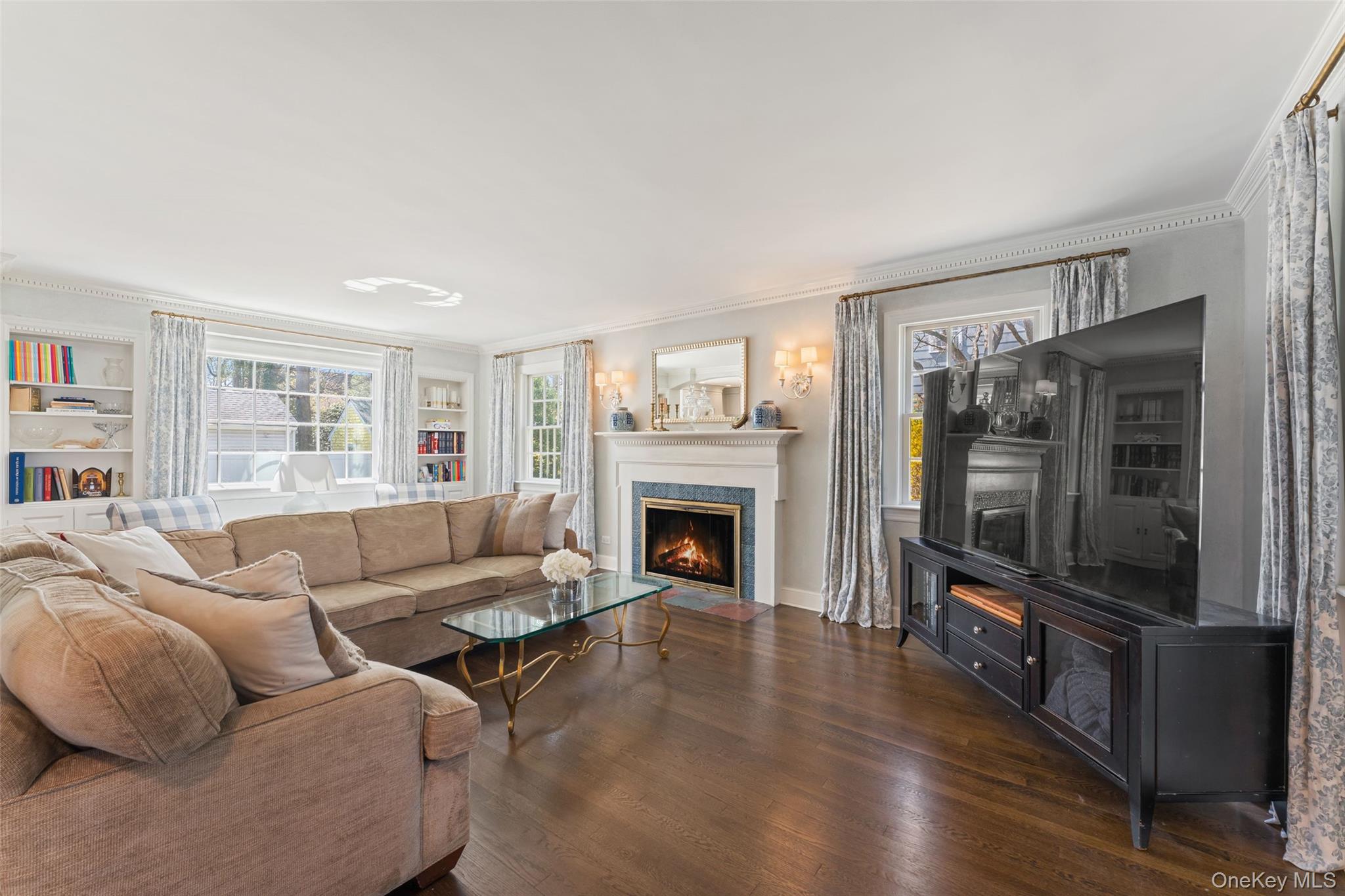 44 Sprague Road Scarsdale, NY 10583 - Photo 6 of 36 Light filled living room with wood burning fireplace and custom built-ins