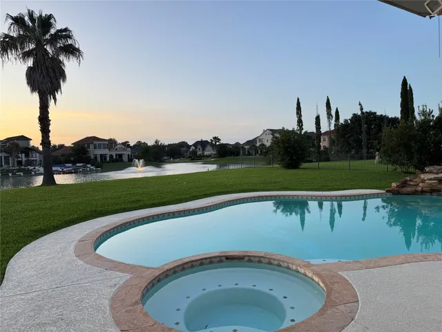 a view of a swimming pool and a yard