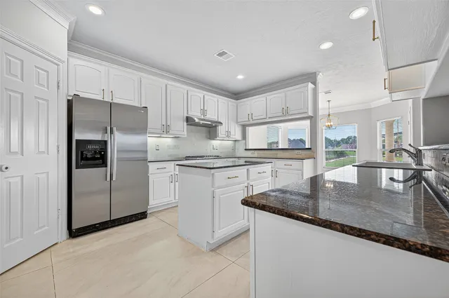 a view of empty room with wooden floor and ceiling fan