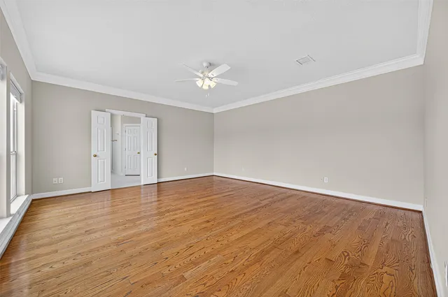 a view of an empty room and wooden floor