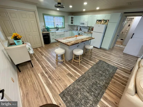 a open kitchen with a sink dining table and chairs