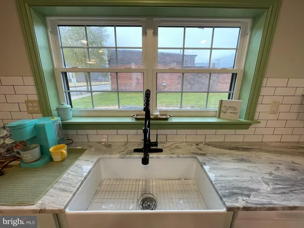 a kitchen with a sink appliances and cabinets