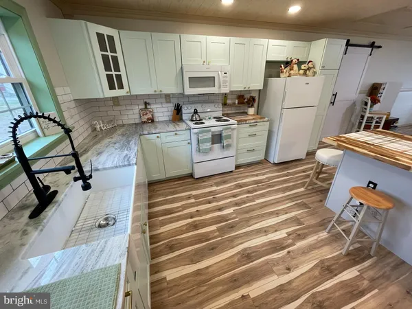 a kitchen with a stove and a refrigerator