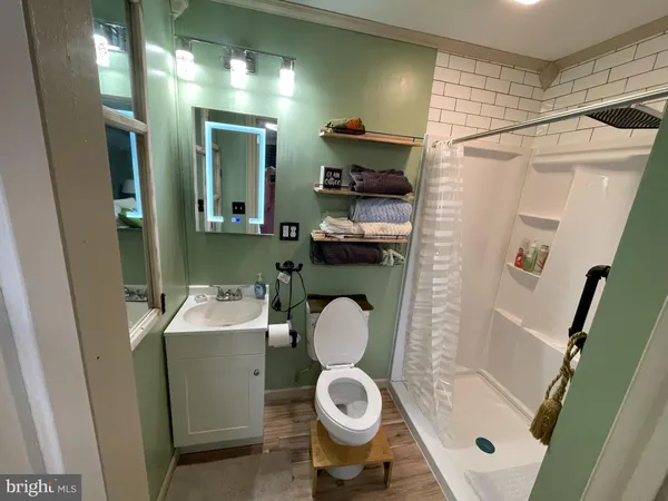 a bedroom with a bed and a mirror