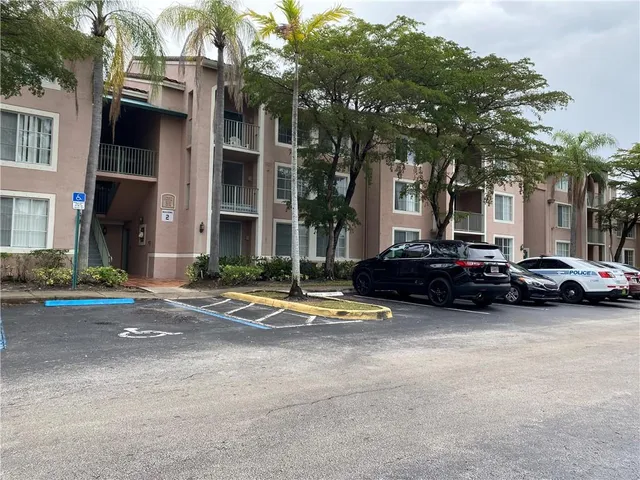 a view of a car park in front of a brick house