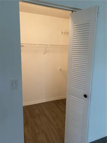 an empty room with a wooden floor and a window