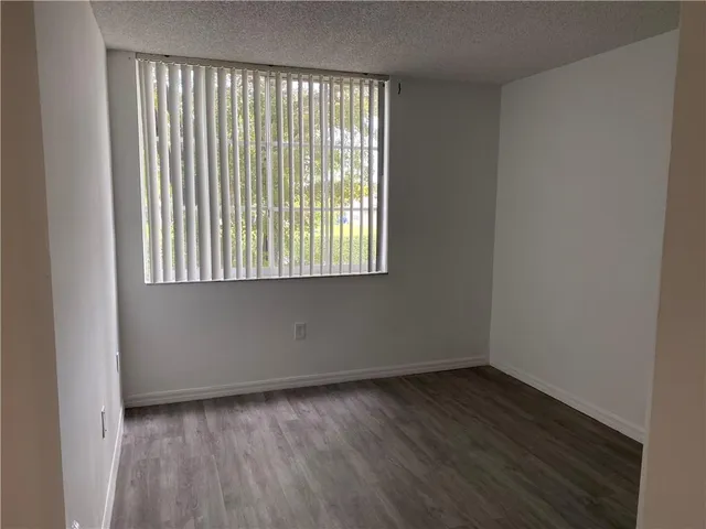 wooden floor and window in an empty room