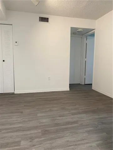 a view of room with wooden floor