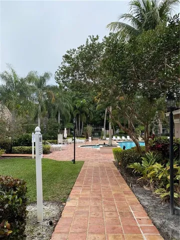 a view of a house with swimming pool and sitting area