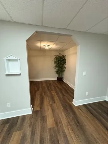 a view of a room with wooden floor and bench