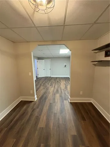 a view of a room with wooden floor