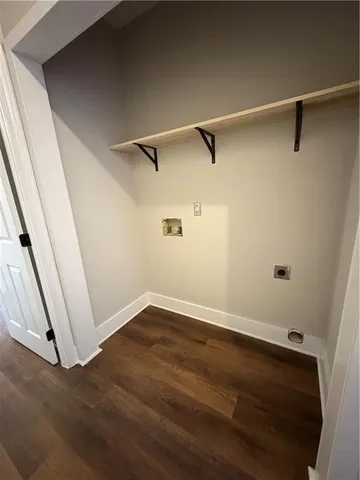 a view of a room with wooden floor and white walls