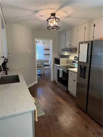 a kitchen with a stove a sink and a refrigerator