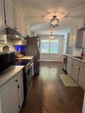 a kitchen with stainless steel appliances granite countertop a stove a sink dishwasher and a refrigerator