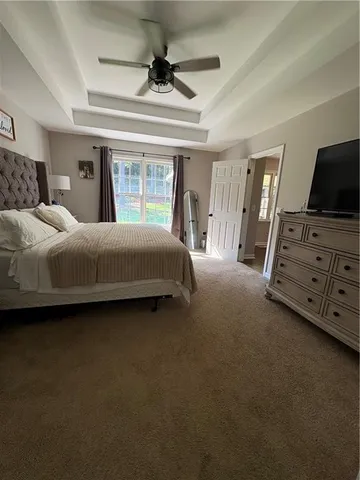 a bedroom with a bed and a tv