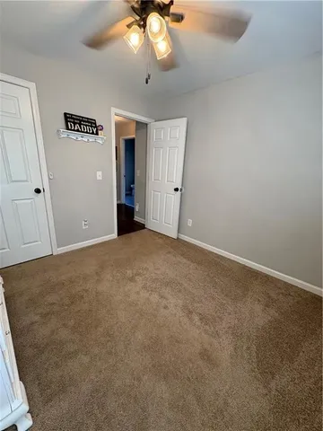 a view of a hallway to rooms and stairs