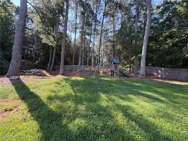 a view of a park with of swings and slides