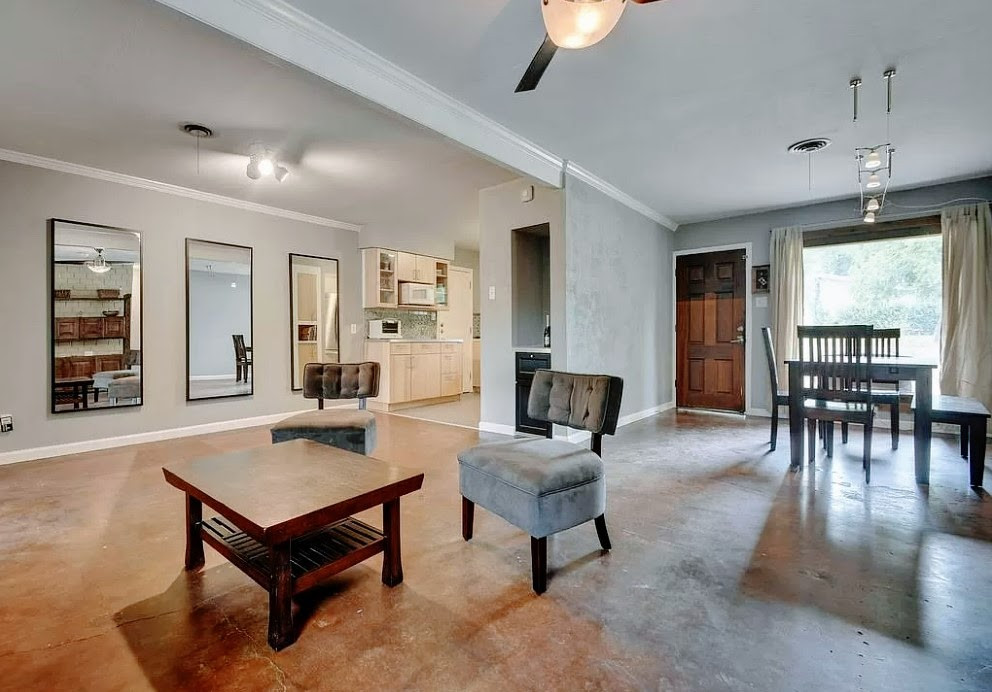 3209 Barton View Drive, Unit A Austin, TX 78735 - Photo 2 of 14 Living room with concrete floors, ornamental molding, and a ceiling fan