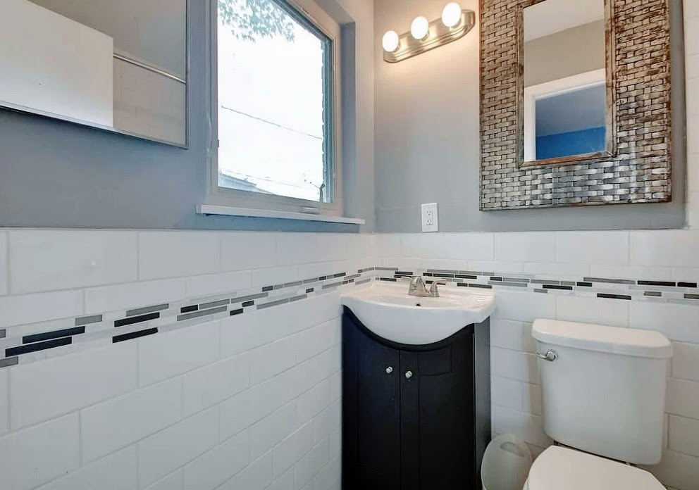 3209 Barton View Drive, Unit A Austin, TX 78735 - Photo 7 of 14 Half bathroom with vanity, tile walls, and wainscoting