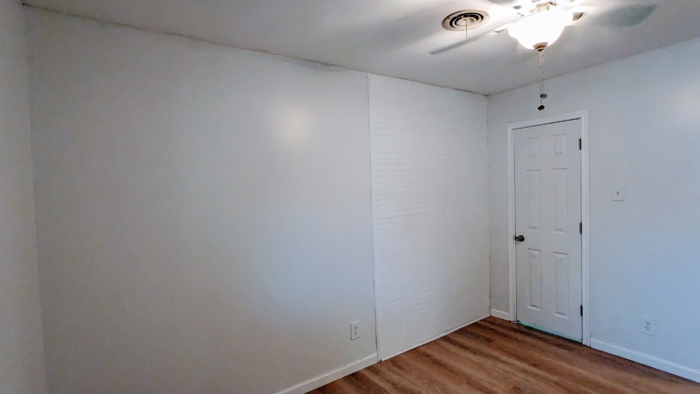 3209 Barton View Drive, Unit A Austin, TX 78735 - Photo 9 of 14 Spare room featuring wood finished floors and ceiling fan
