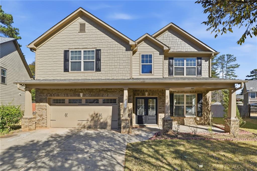 5045 Racquet Court Duluth, GA 30096 - Photo 1 of 1 a view of a white house with large windows and a small yard