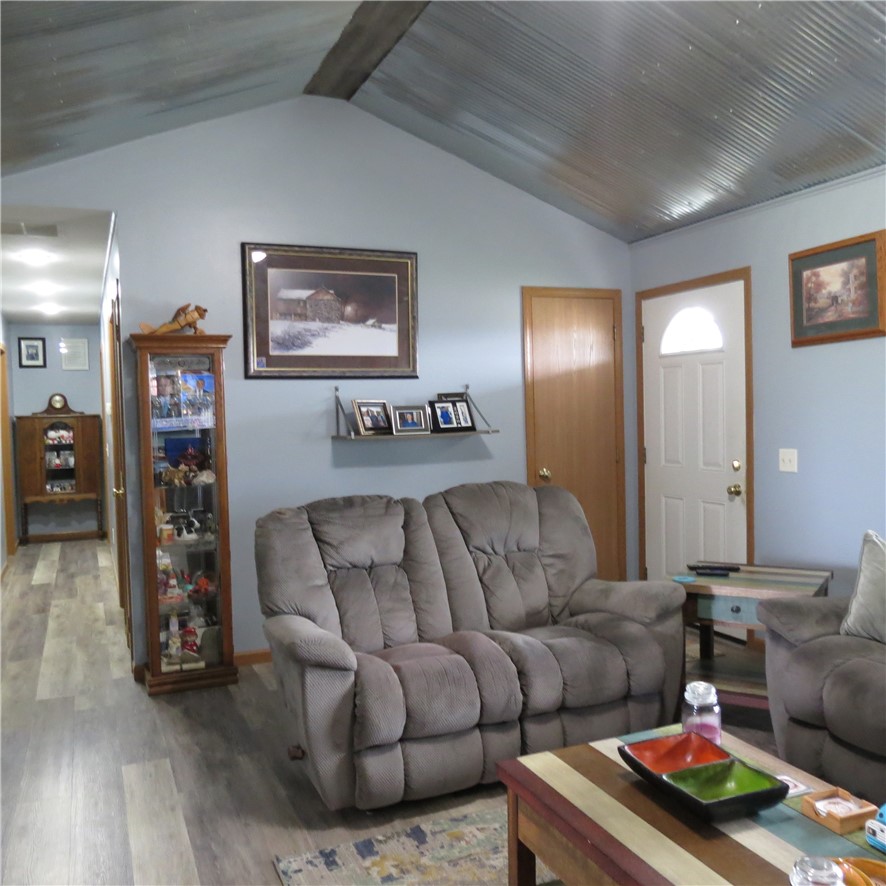 21242 Dingman-Slagle Road Pemberton, OH 45353 - Photo 7 of 33 This living room features a vaulted ceiling and durable flooring, perfect for comfortable daily living.