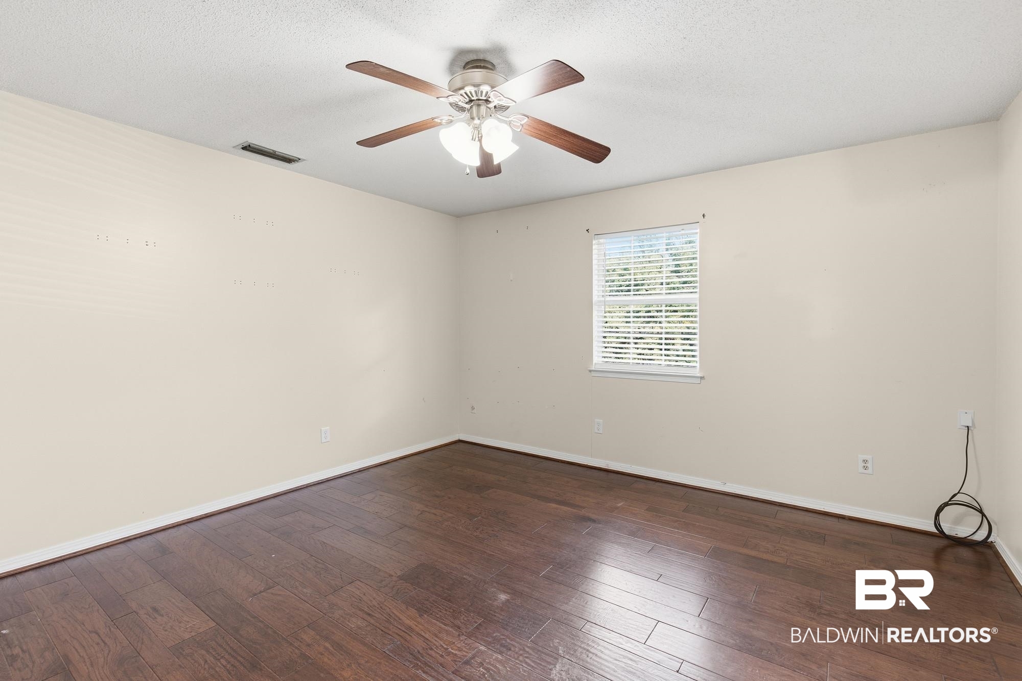 9215 Shiloh Drive Mobile, AL 36695 - Photo 26 of 32 Spare room with dark wood finished floors, a textured ceiling, and a ceiling fan