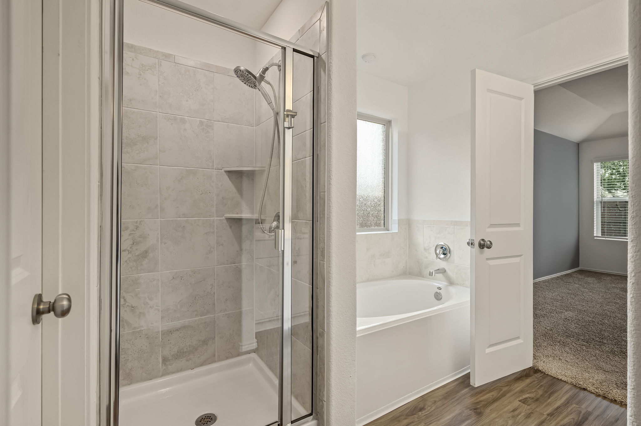 3489 Pauling Loop Round Rock, TX 78665 - Photo 11 of 32 The primary bathroom is a stand up shower and garden tub to relax after a long day.