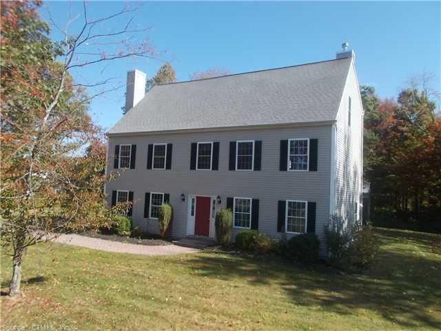a view of a house with pool and a yard