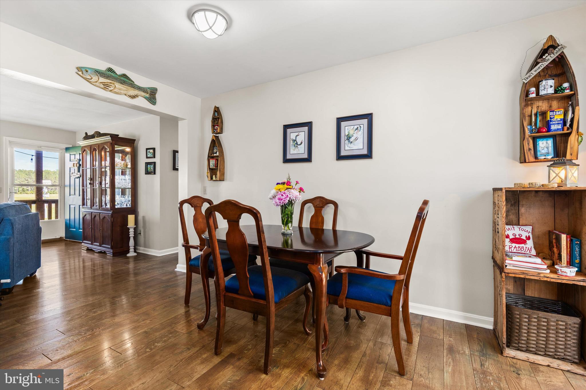 3620 Country Club Road Crisfield, MD 21817 - Photo 18 of 62 a view of a dining room with furniture and a book shelf