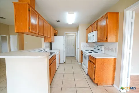 a kitchen with stainless steel appliances granite countertop a sink and cabinets