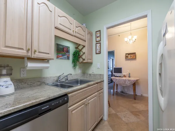 a kitchen with stainless steel appliances granite countertop a sink and cabinets
