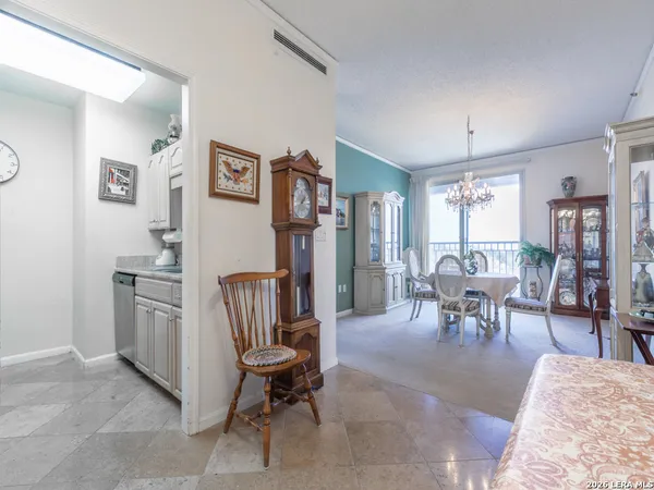 a living room with furniture a dining table and chairs with wooden floor