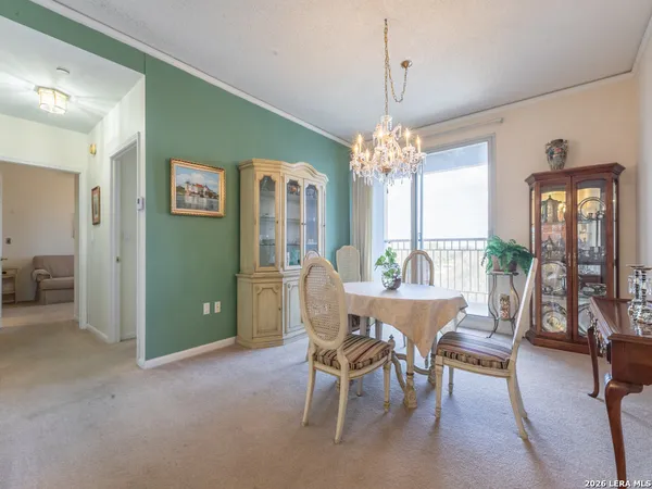 a view of a dining room with furniture wooden floor and chandelier