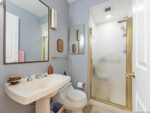 a bathroom with a sink toilet and shower