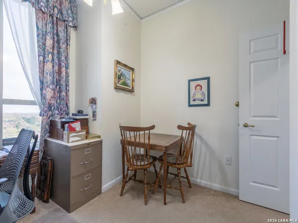 a view of a room with workspace and a window
