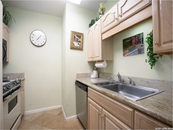 a kitchen with stainless steel appliances granite countertop a sink and a granite counter tops