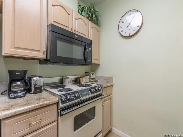 a stove top oven sitting inside of a kitchen