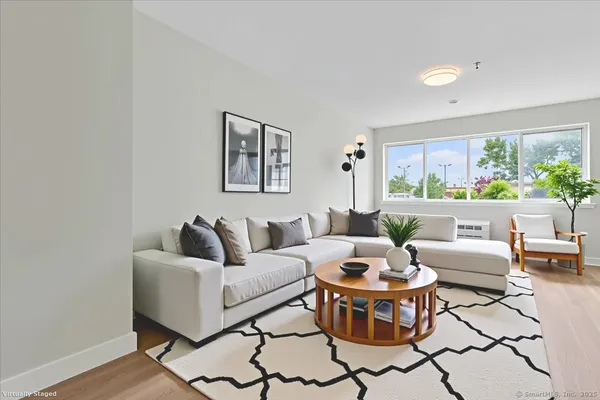 a living room with furniture and a wooden floor