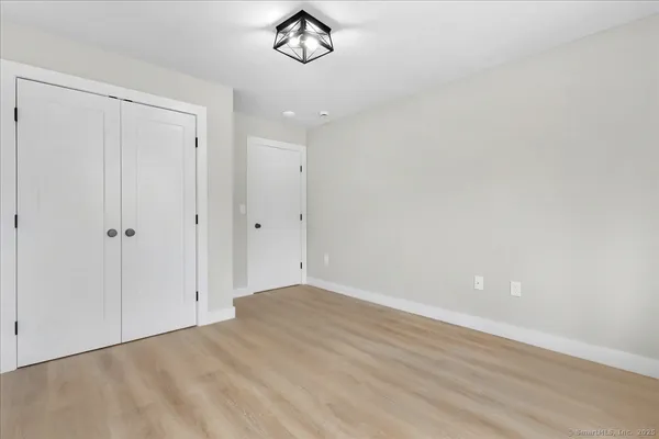 a view of a room with wooden floor and white doors