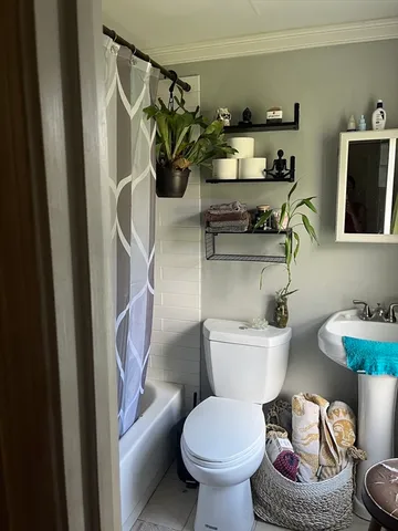 a bathroom with a toilet a sink and a mirror